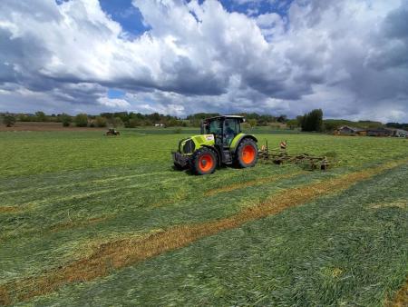 Tractor working on a green field