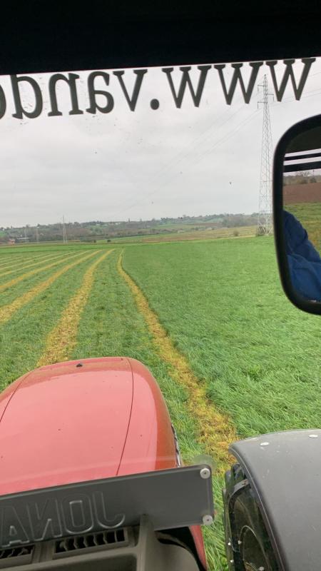Tractor drivers view from the tractor of a green field in front of it